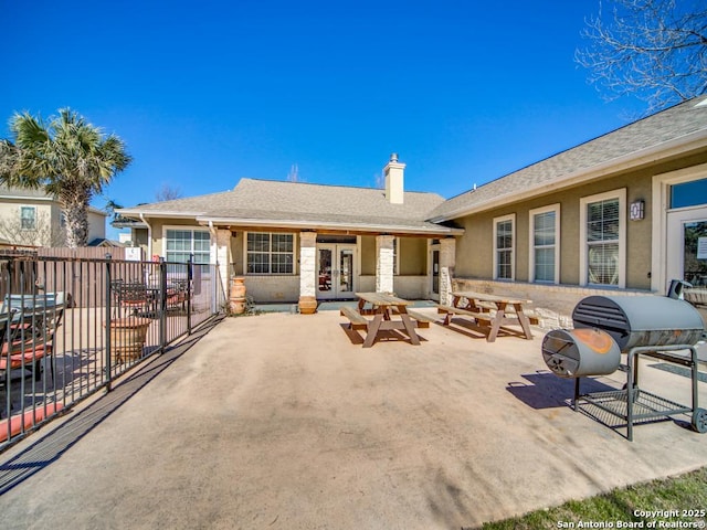 rear view of house featuring a patio and french doors