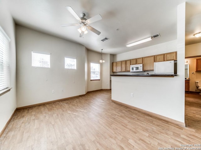 kitchen with hanging light fixtures, ceiling fan, white appliances, and light hardwood / wood-style flooring