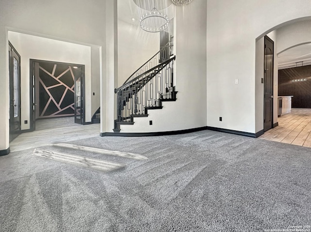 interior space with a high ceiling and a chandelier