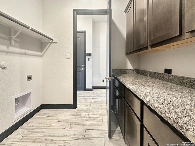 laundry room with cabinets and hookup for an electric dryer