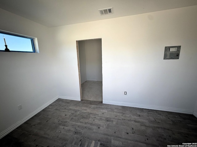 spare room featuring dark hardwood / wood-style floors