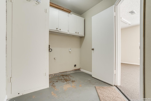 laundry area with cabinets, hookup for an electric dryer, and a textured ceiling