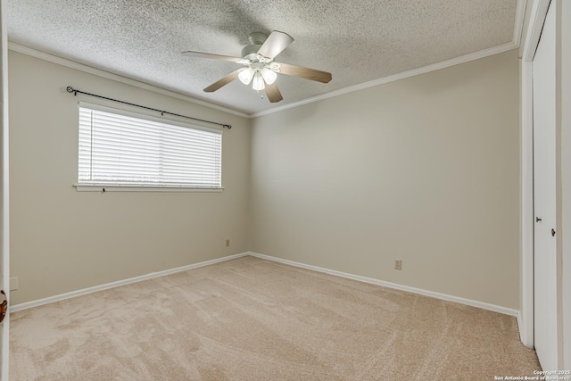 carpeted spare room with crown molding, ceiling fan, and a textured ceiling