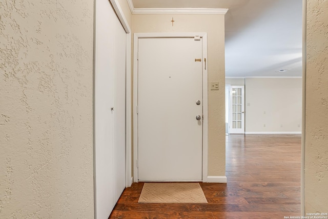 entryway with crown molding and dark wood-type flooring