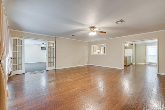 spare room with hardwood / wood-style flooring, ornamental molding, french doors, and ceiling fan