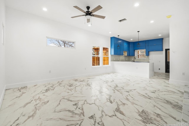 unfurnished living room with sink and ceiling fan