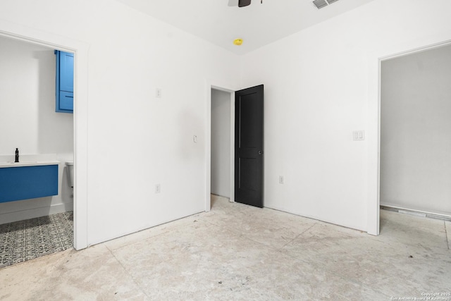 unfurnished bedroom with connected bathroom and ceiling fan