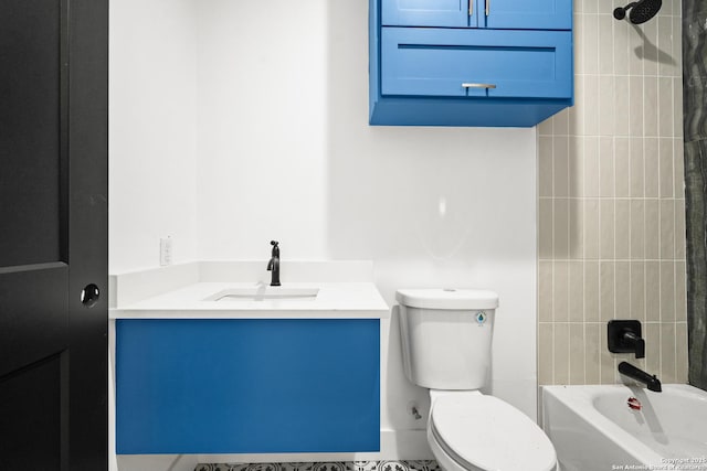 full bathroom with vanity, tiled shower / bath combo, and toilet