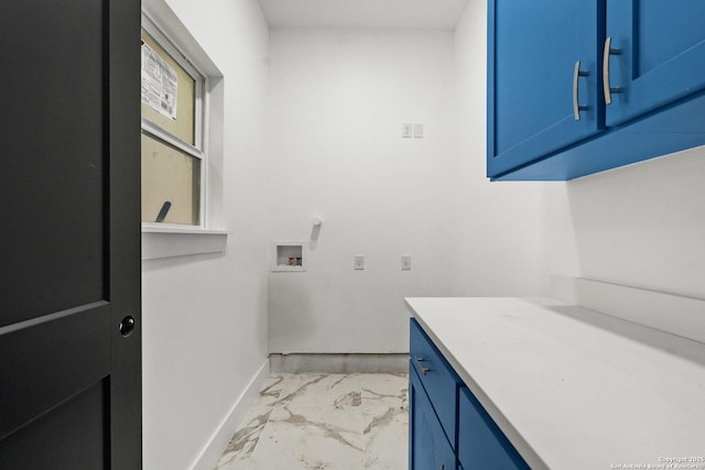 clothes washing area with cabinets and hookup for a washing machine