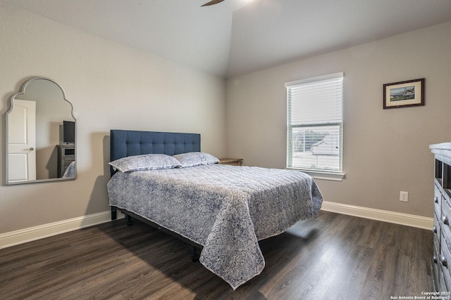 bedroom with vaulted ceiling, ceiling fan, and dark hardwood / wood-style flooring