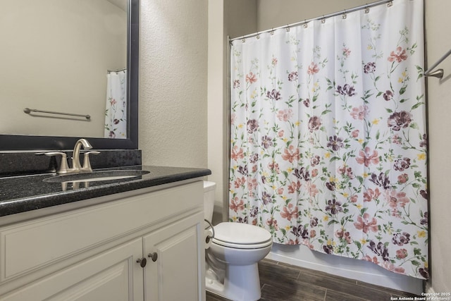 bathroom featuring hardwood / wood-style flooring, vanity, a shower with curtain, and toilet