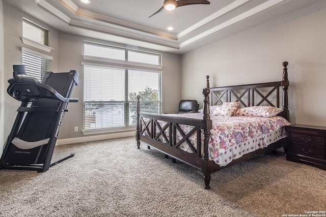 carpeted bedroom featuring crown molding, ceiling fan, and a tray ceiling