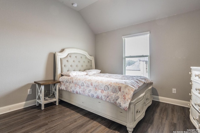 bedroom featuring lofted ceiling and dark hardwood / wood-style flooring