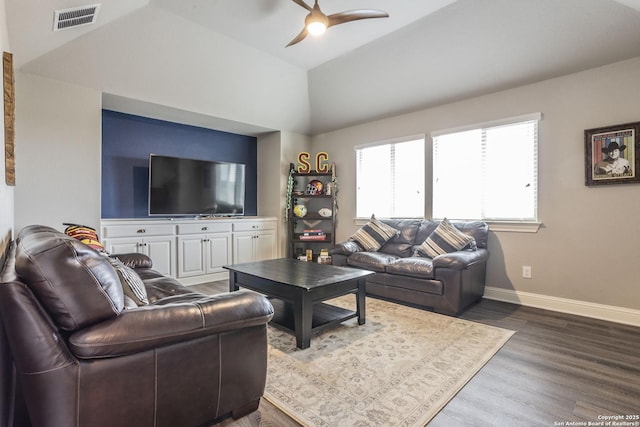 living room featuring wood-type flooring, ceiling fan, and vaulted ceiling