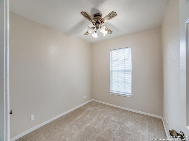 carpeted empty room featuring ceiling fan