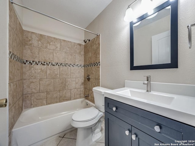 full bathroom featuring tiled shower / bath combo, vanity, tile patterned floors, and toilet