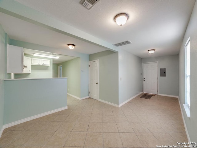 spare room with electric panel and light tile patterned floors