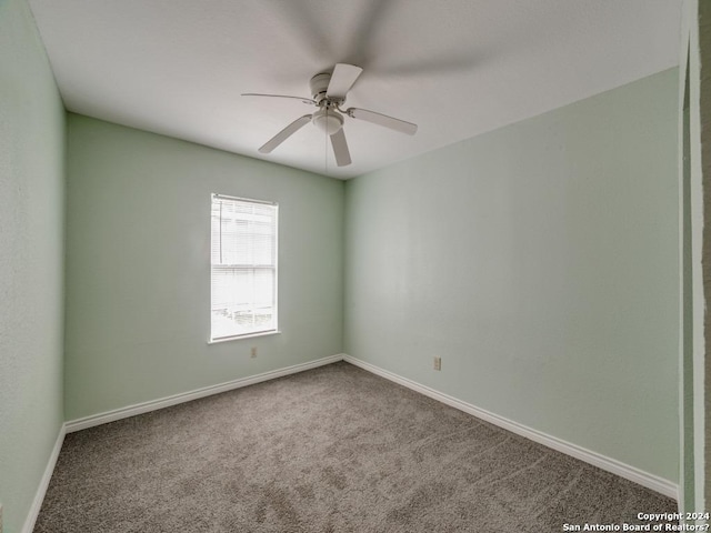 spare room featuring carpet and ceiling fan