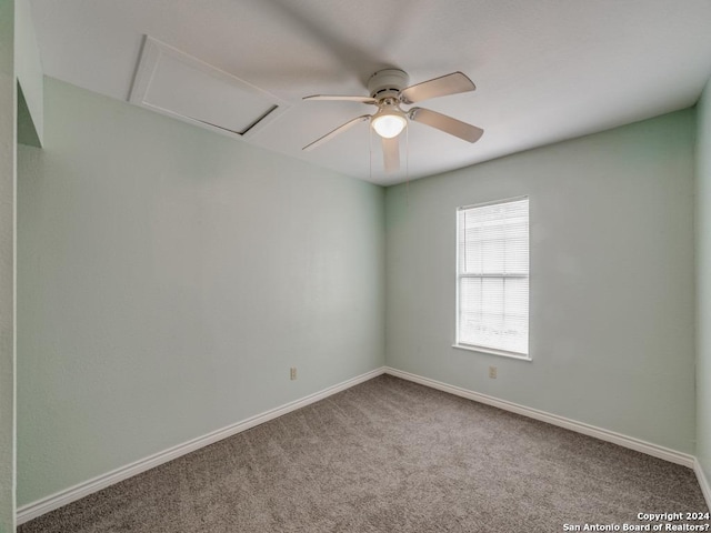 carpeted spare room with ceiling fan