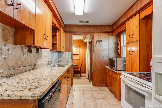 kitchen featuring sink, backsplash, black dishwasher, light stone counters, and white electric stove