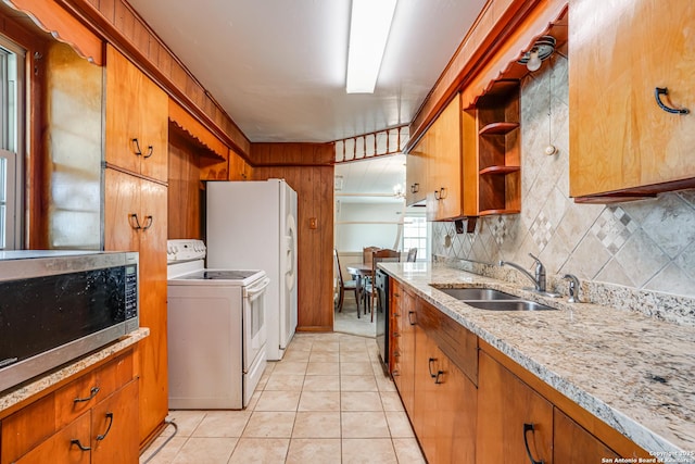 kitchen with light tile patterned flooring, white electric range, sink, light stone counters, and decorative backsplash