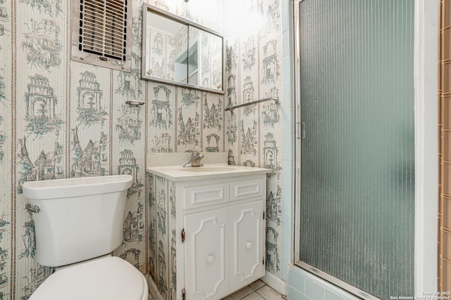 bathroom featuring walk in shower, tile patterned floors, toilet, and vanity