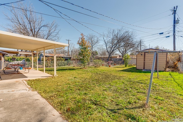 view of yard featuring a shed and a patio area