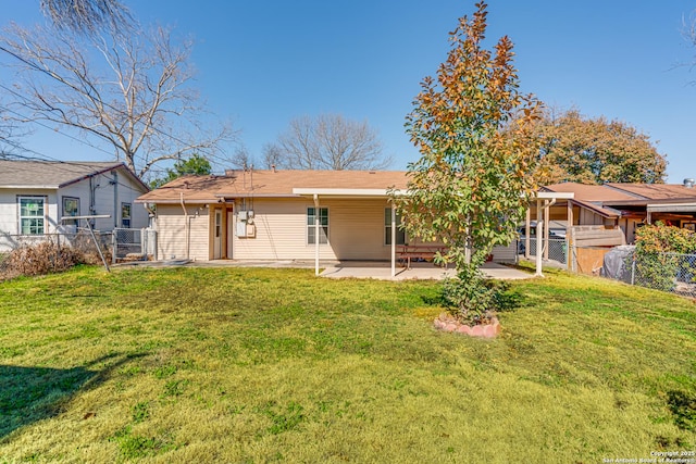 back of property with a patio and a lawn