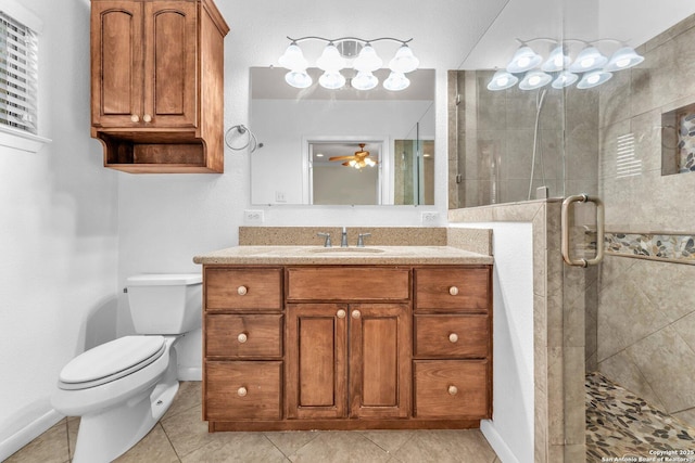 bathroom featuring walk in shower, toilet, vanity, ceiling fan, and tile patterned flooring