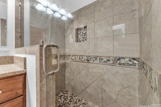 bathroom with vanity and a shower with shower door