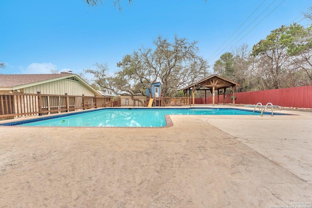 view of swimming pool featuring a gazebo and a shed