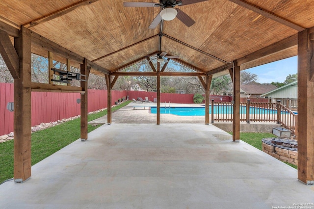 view of patio with a fenced in pool and ceiling fan