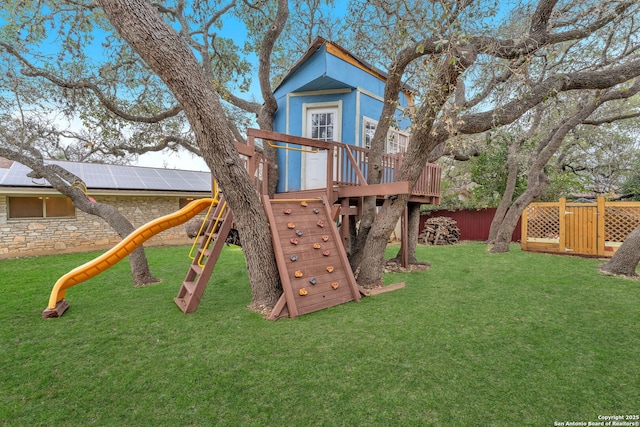 view of playground with a lawn