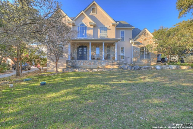 view of front facade with a front yard and a porch