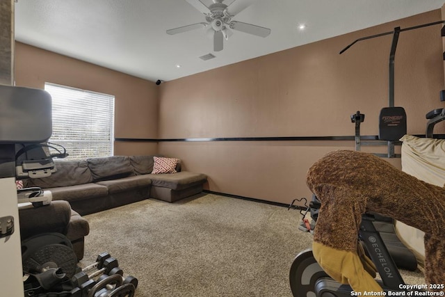 carpeted living room with ceiling fan