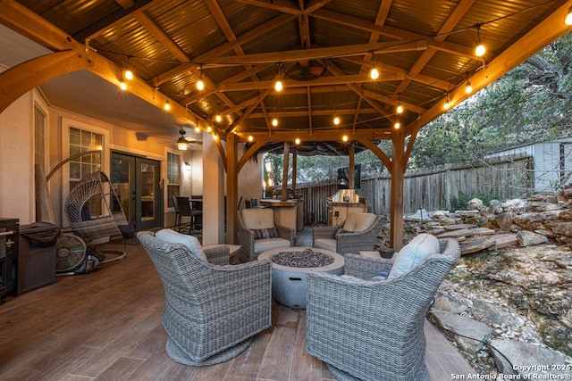 view of patio featuring ceiling fan and a fire pit