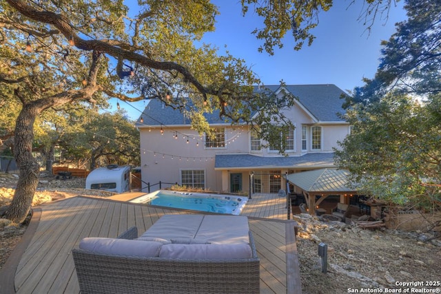 exterior space with a wooden deck and a gazebo