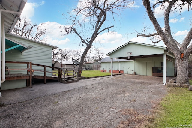 exterior space with a carport and a deck