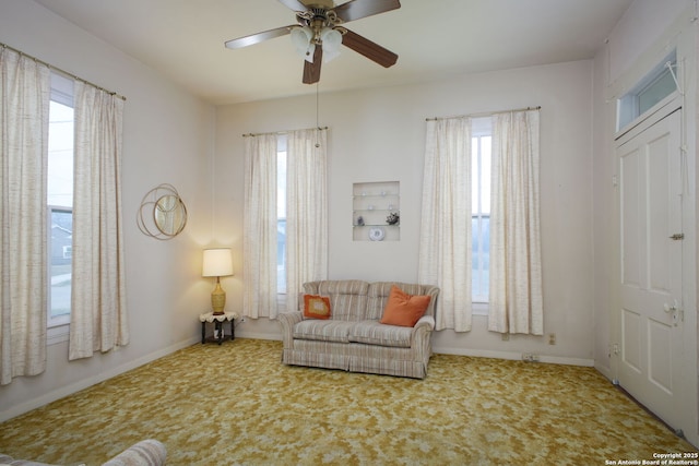 living area with carpet floors and ceiling fan