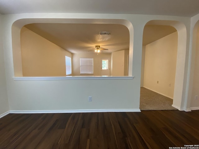 spare room with dark hardwood / wood-style floors and ceiling fan