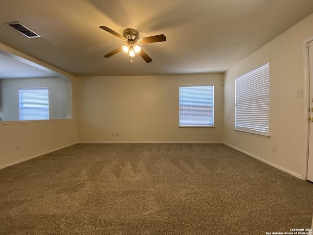 unfurnished room featuring a wealth of natural light, ceiling fan, and carpet flooring