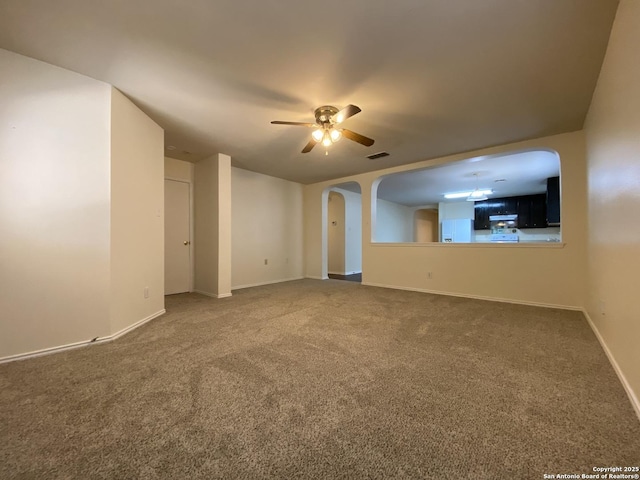 unfurnished living room featuring ceiling fan and carpet