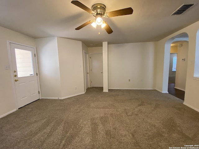 carpeted spare room featuring ceiling fan