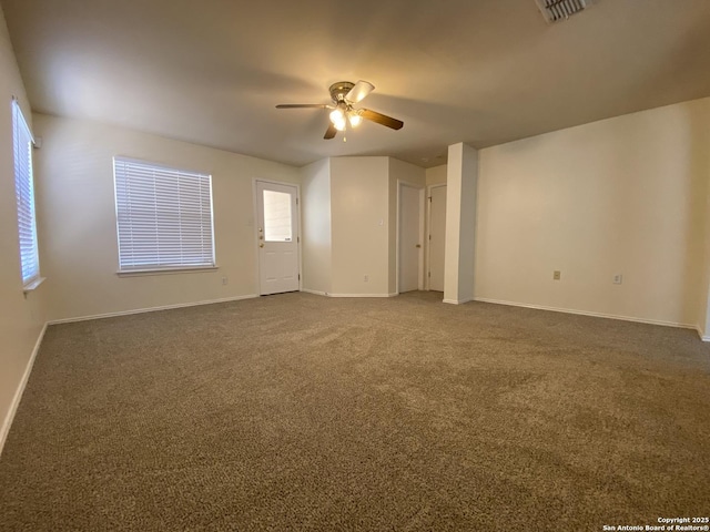 carpeted empty room featuring ceiling fan