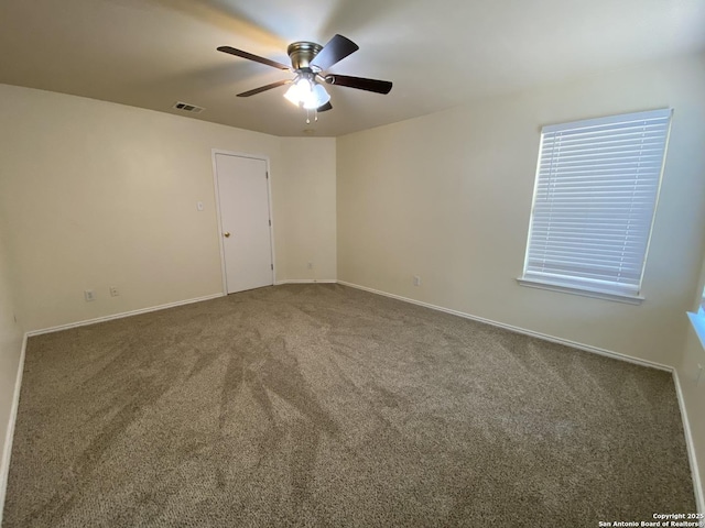 carpeted empty room featuring ceiling fan