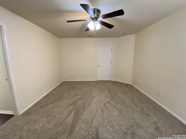 carpeted spare room featuring ceiling fan