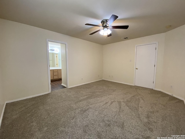 unfurnished room with ceiling fan and dark colored carpet