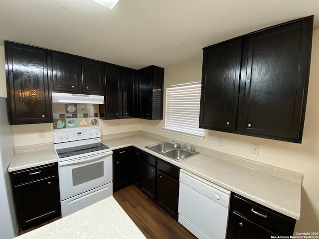 kitchen featuring dark hardwood / wood-style floors, sink, and white appliances