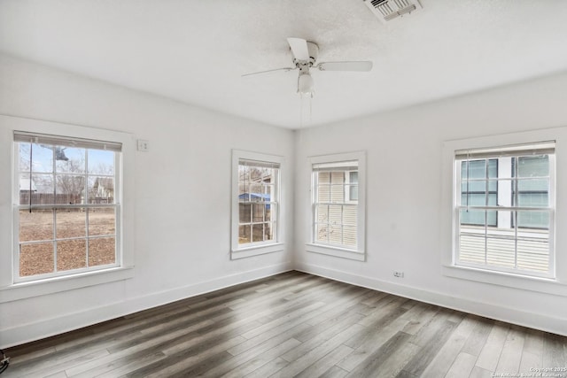 empty room with ceiling fan and hardwood / wood-style floors