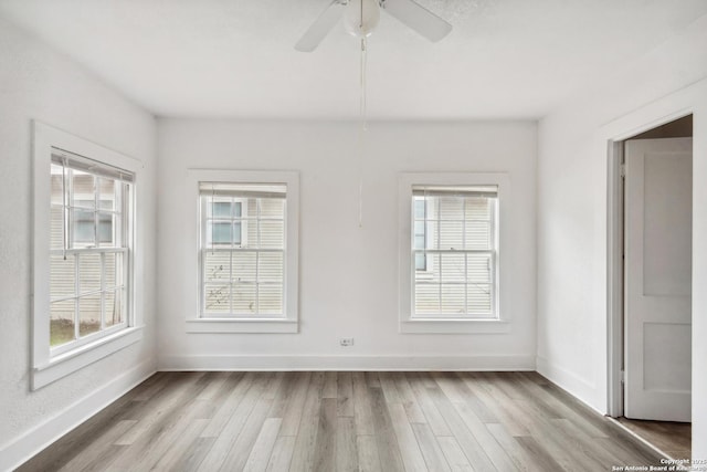 empty room with hardwood / wood-style flooring and ceiling fan